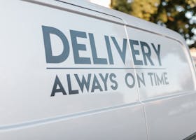 Close-up of delivery van with slogan 'Always On Time' emphasizing timely service.